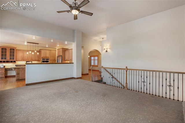 unfurnished living room with ceiling fan