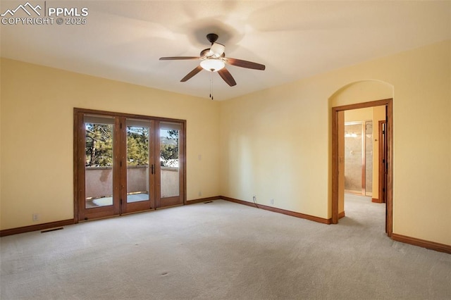 carpeted spare room featuring ceiling fan