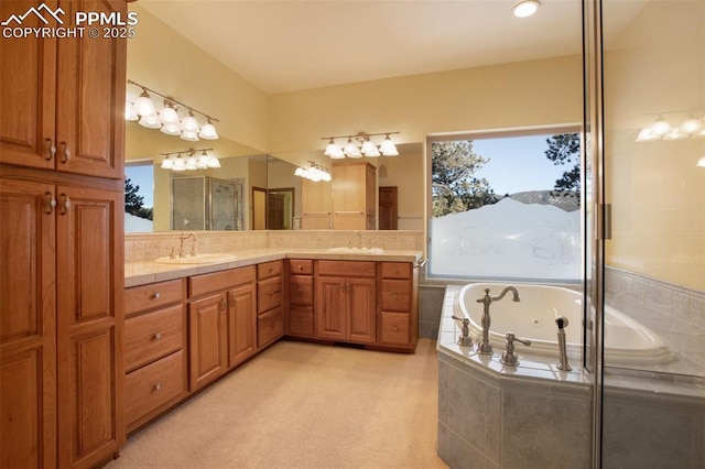 bathroom with vanity and tiled tub