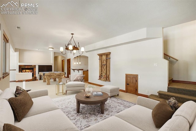 carpeted living room featuring an inviting chandelier