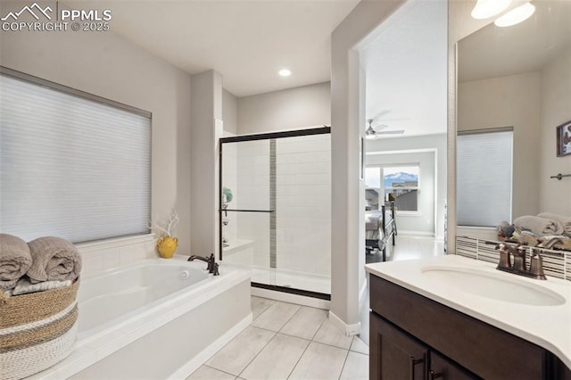 bathroom with tile patterned flooring, shower with separate bathtub, and vanity