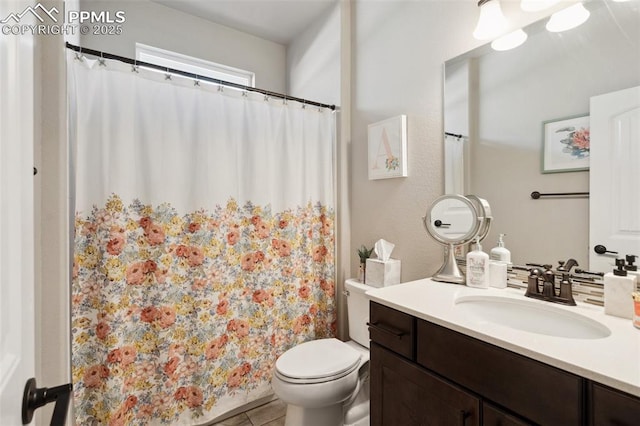 bathroom featuring vanity, tile patterned floors, and toilet