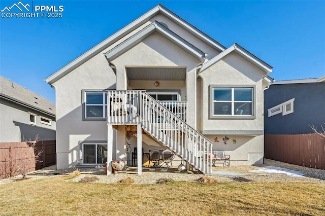 rear view of property featuring a yard