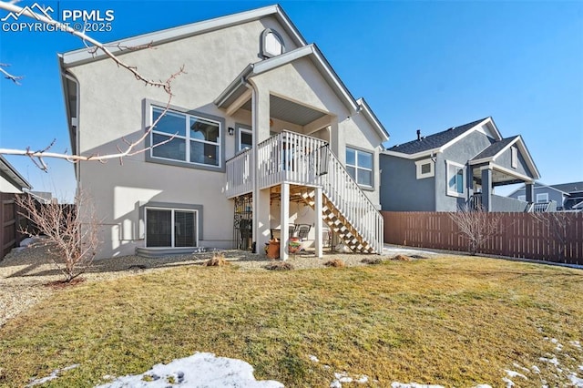 rear view of house featuring a yard and a deck