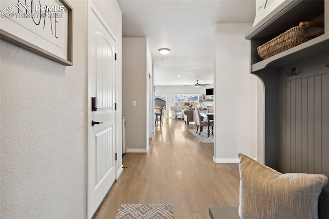 mudroom with light hardwood / wood-style flooring and ceiling fan