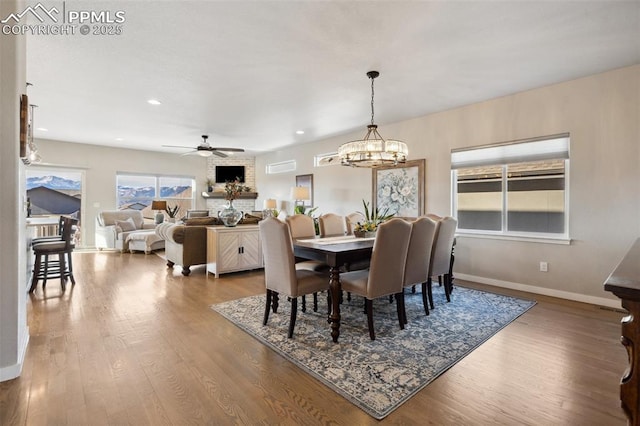 dining area with ceiling fan and wood-type flooring