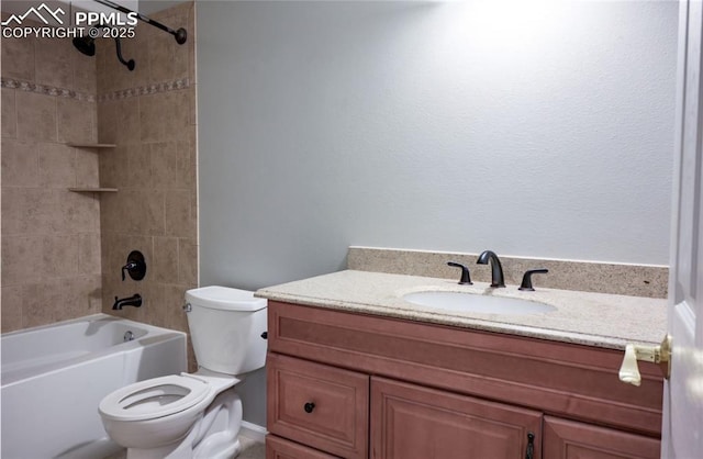 full bathroom featuring vanity, tiled shower / bath, and toilet