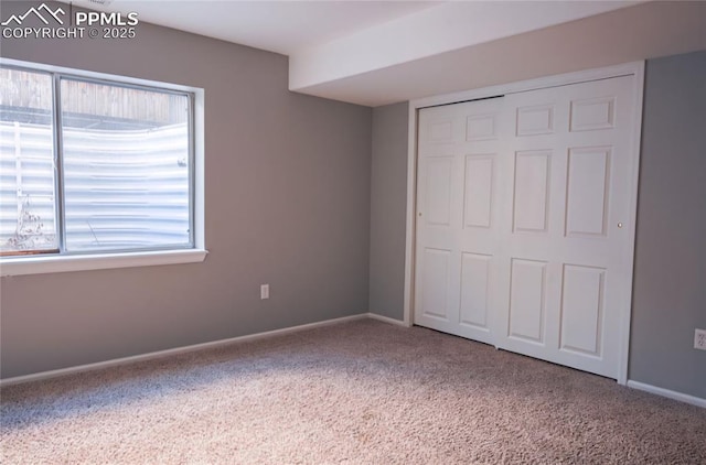 unfurnished bedroom with carpet floors and a closet