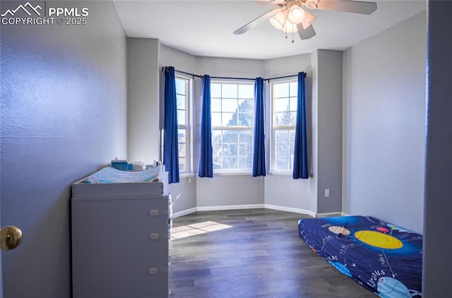 bedroom with ceiling fan and dark hardwood / wood-style floors