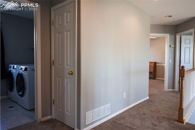 hallway featuring separate washer and dryer and carpet