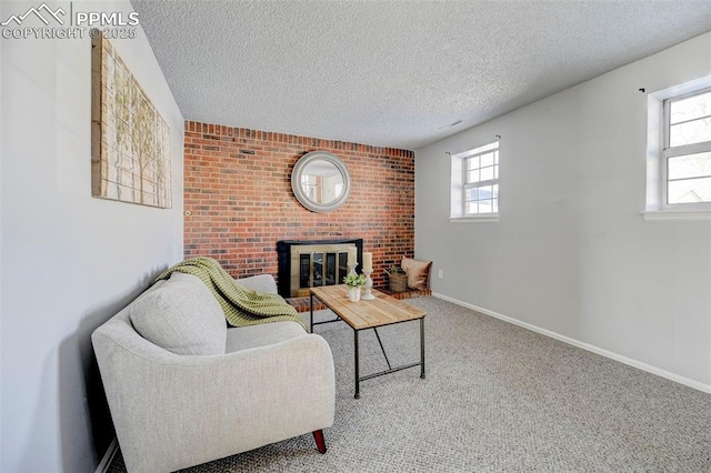 carpeted living room with a fireplace and a textured ceiling