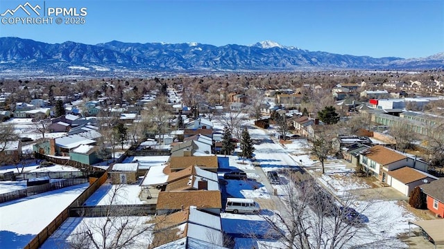 snowy aerial view featuring a mountain view