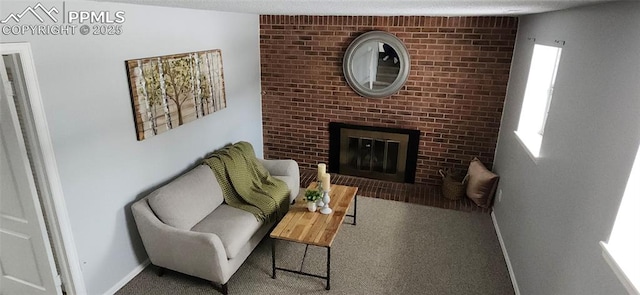 carpeted living room featuring a brick fireplace