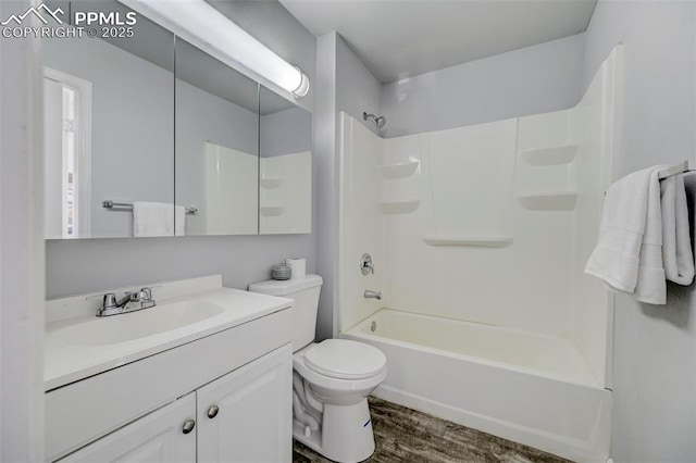 full bathroom with hardwood / wood-style flooring, vanity, toilet, and shower / bathing tub combination