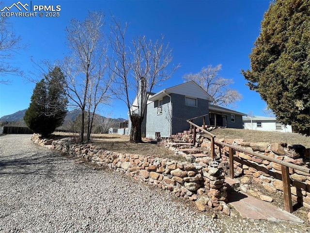 view of side of home with a mountain view