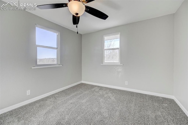 carpeted spare room featuring ceiling fan