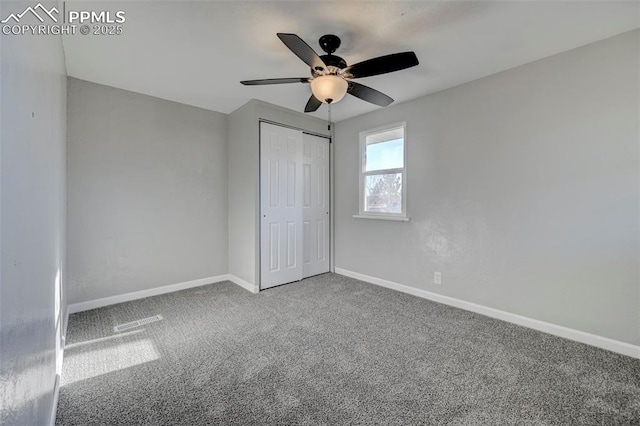 unfurnished bedroom featuring carpet floors, ceiling fan, and a closet