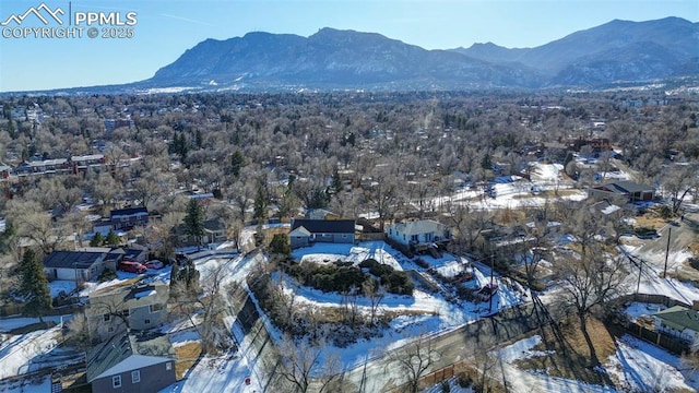 snowy aerial view featuring a mountain view