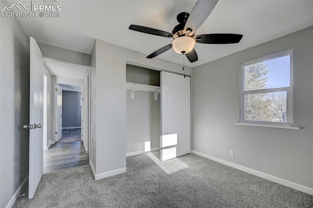 unfurnished bedroom with ceiling fan, carpet floors, and a closet