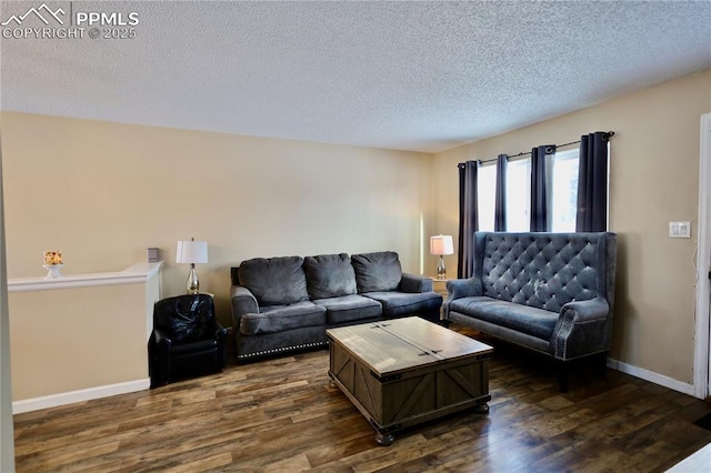 living room with dark hardwood / wood-style flooring and a textured ceiling