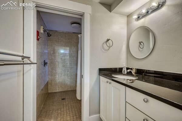 bathroom featuring tile patterned flooring, vanity, and a shower with curtain