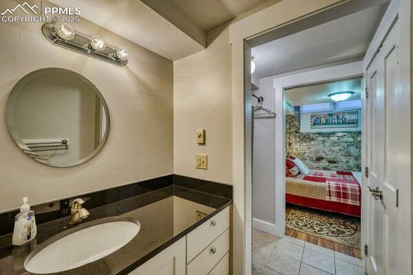 bathroom with tile patterned floors and vanity