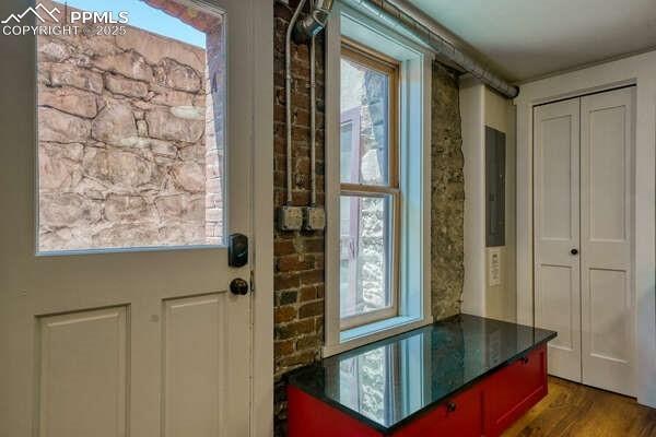 entryway with dark hardwood / wood-style flooring