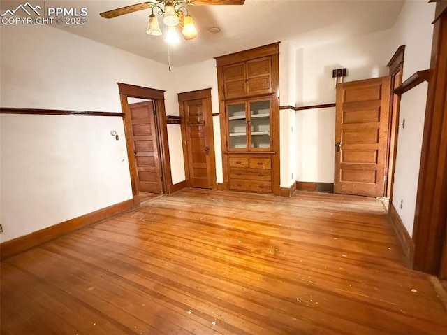 unfurnished bedroom featuring ceiling fan and light hardwood / wood-style flooring