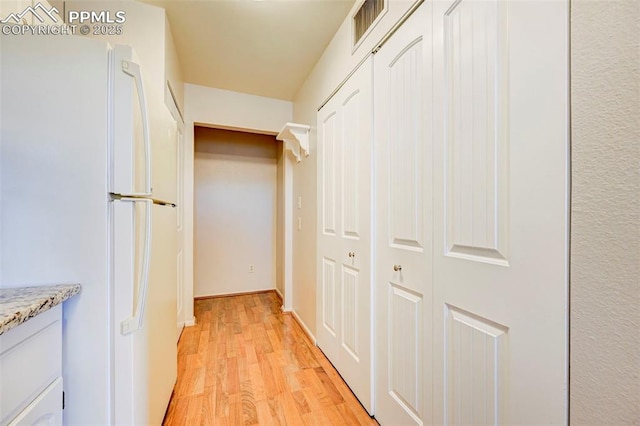 corridor featuring light hardwood / wood-style floors