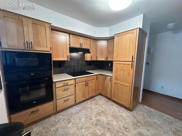 kitchen with black appliances, tasteful backsplash, and a textured ceiling