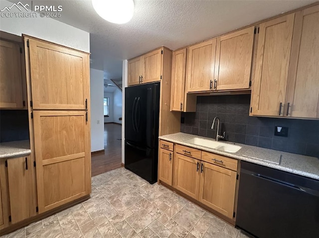 kitchen featuring tasteful backsplash, black appliances, sink, a textured ceiling, and light stone counters