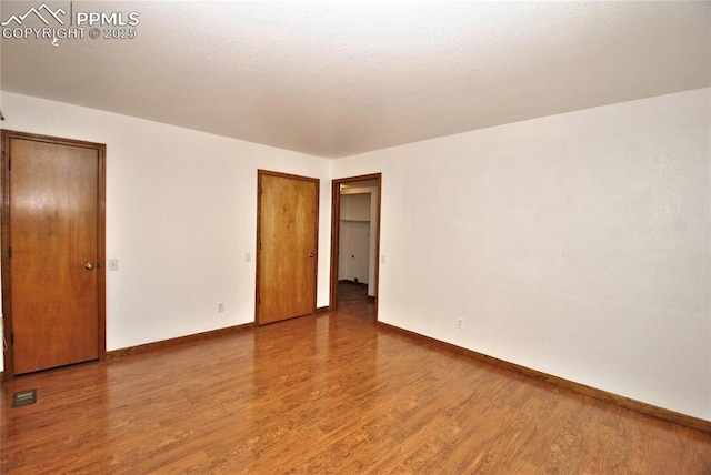 spare room featuring hardwood / wood-style flooring