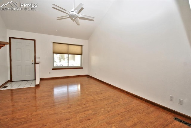 empty room with light hardwood / wood-style floors, high vaulted ceiling, and ceiling fan