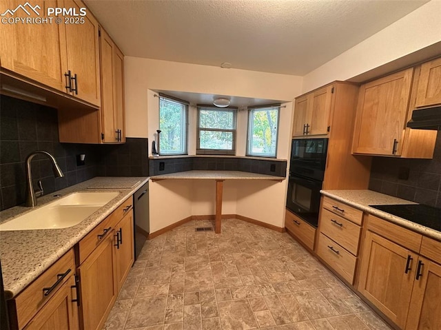 kitchen featuring light stone counters, sink, backsplash, and black appliances