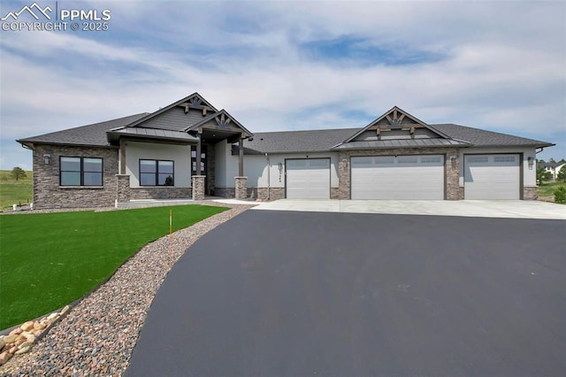 craftsman inspired home with metal roof, a garage, driveway, a front lawn, and a standing seam roof