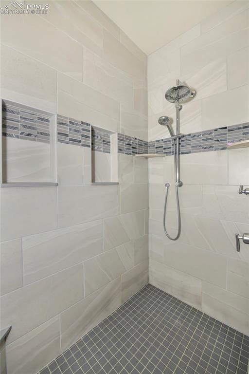 bathroom with tiled shower