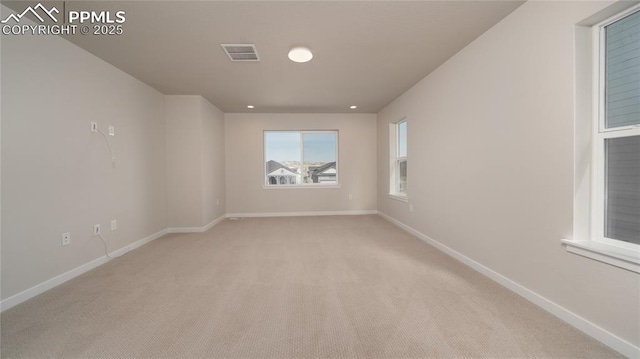 unfurnished room with recessed lighting, visible vents, light carpet, and baseboards