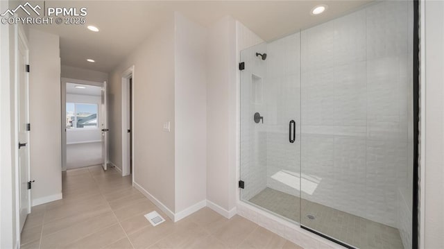 bathroom with a stall shower, tile patterned flooring, and recessed lighting