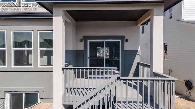 property entrance with stucco siding