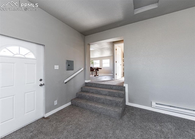 carpeted foyer entrance featuring a textured ceiling and baseboard heating