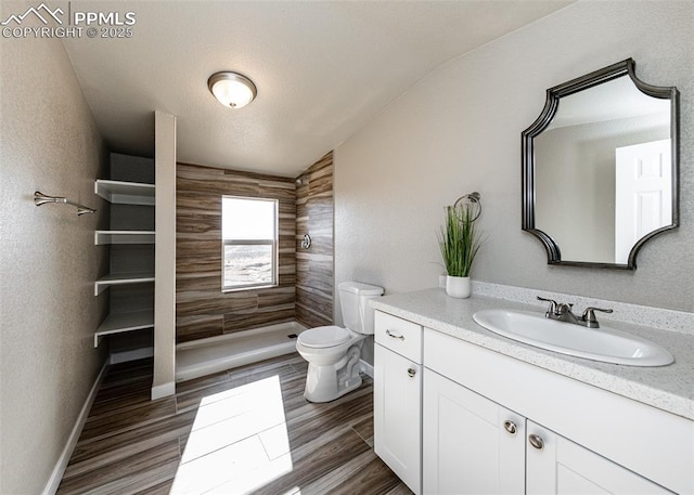 bathroom with vanity, hardwood / wood-style flooring, a shower, and toilet