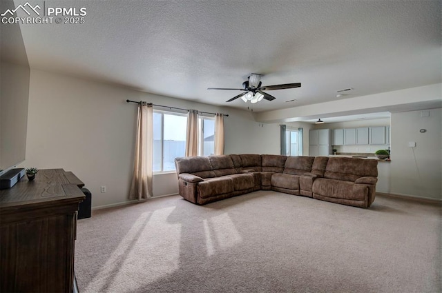 carpeted living room featuring a textured ceiling and ceiling fan