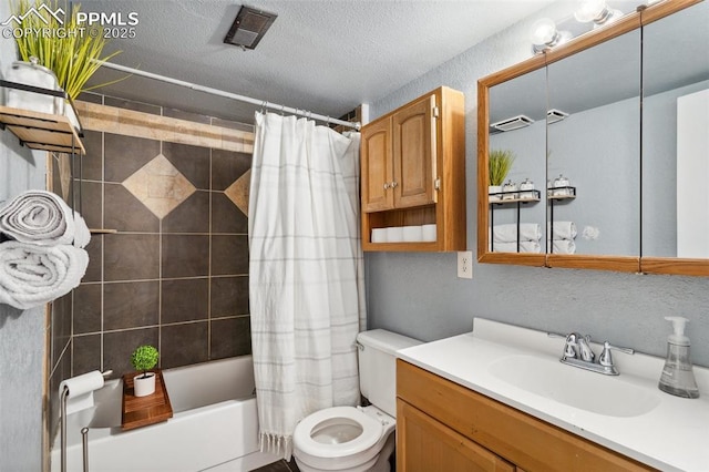 full bathroom with vanity, a textured ceiling, shower / bath combination with curtain, and toilet