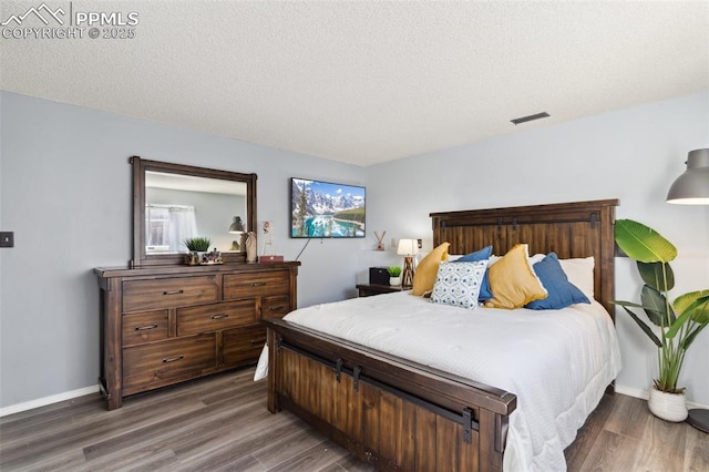 bedroom with dark wood-type flooring and a textured ceiling