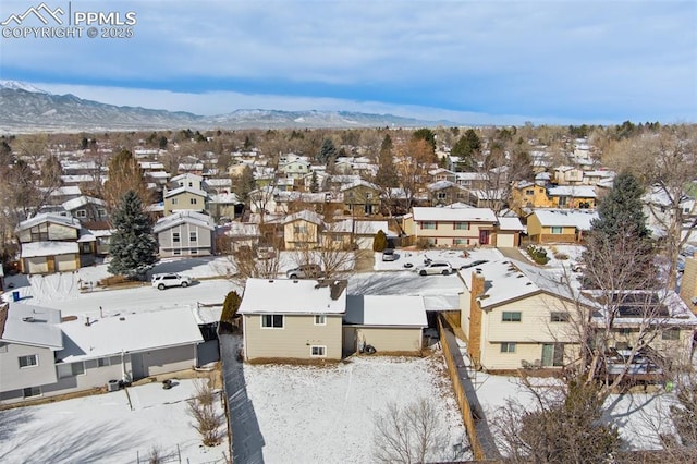 snowy aerial view featuring a mountain view