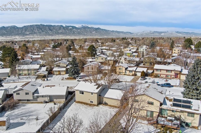 snowy aerial view featuring a mountain view