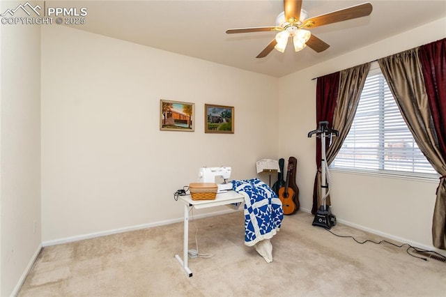 interior space with ceiling fan and light colored carpet