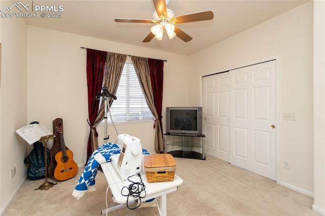 recreation room with ceiling fan and light carpet