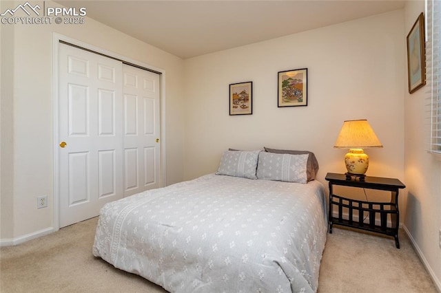 bedroom featuring light colored carpet and a closet