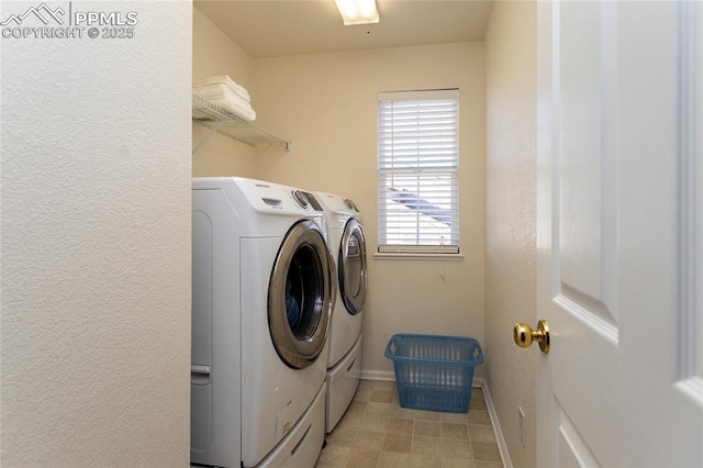 clothes washing area with washer and dryer